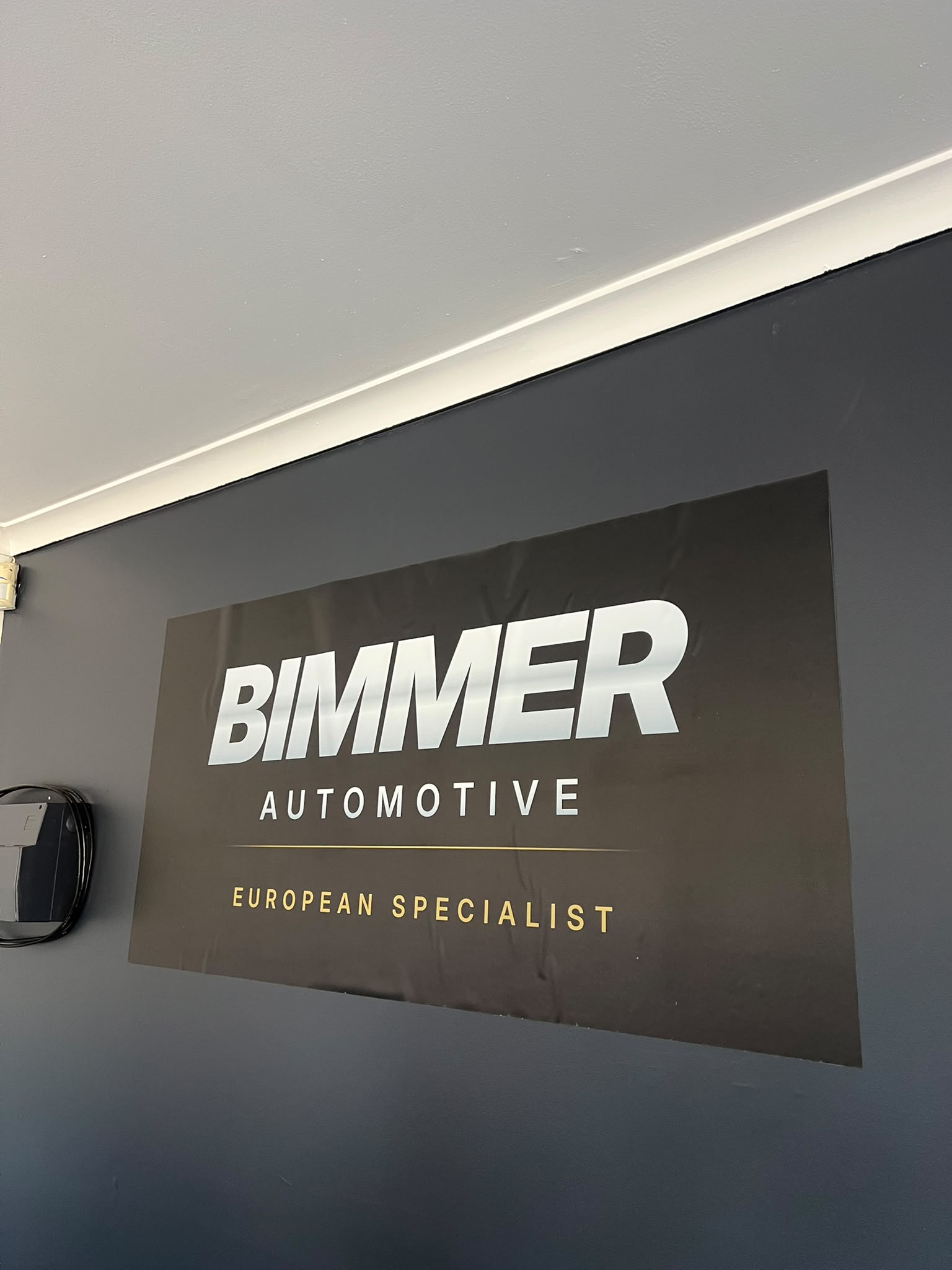 BIMMER AUTOMOTIVE European Specialist signage on the workshop wall